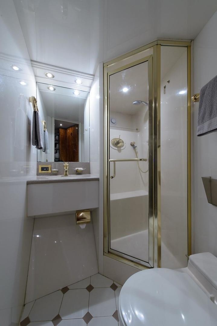 a bathroom with a glass shower door aboard BIG WAVE Yacht for Sale