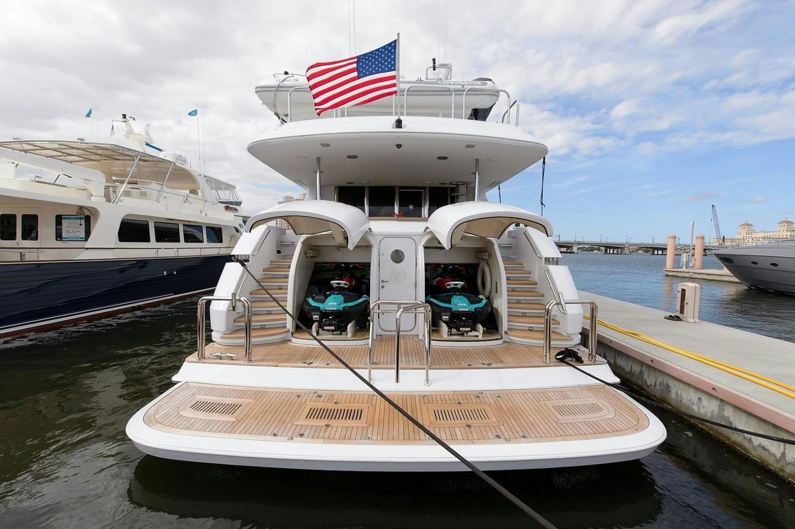 a boat with a flag on the deck aboard BIG WAVE Yacht for Sale