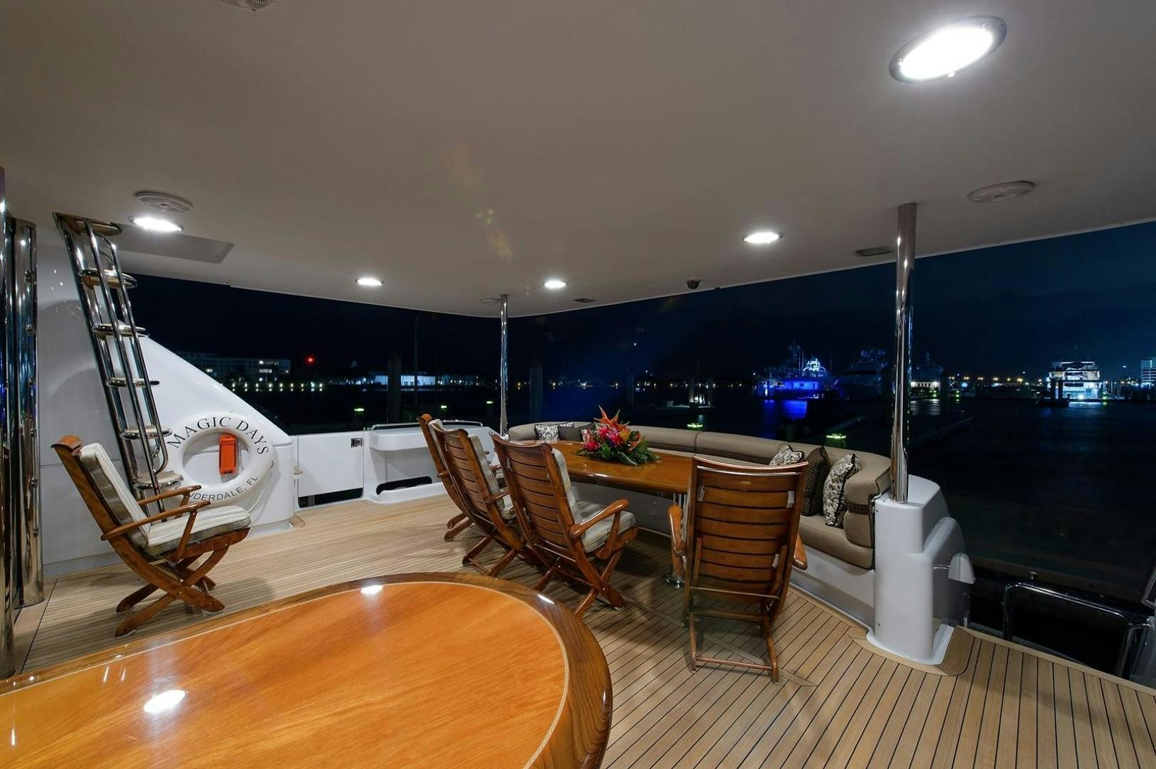 a room with a table and chairs aboard BIG WAVE Yacht for Sale