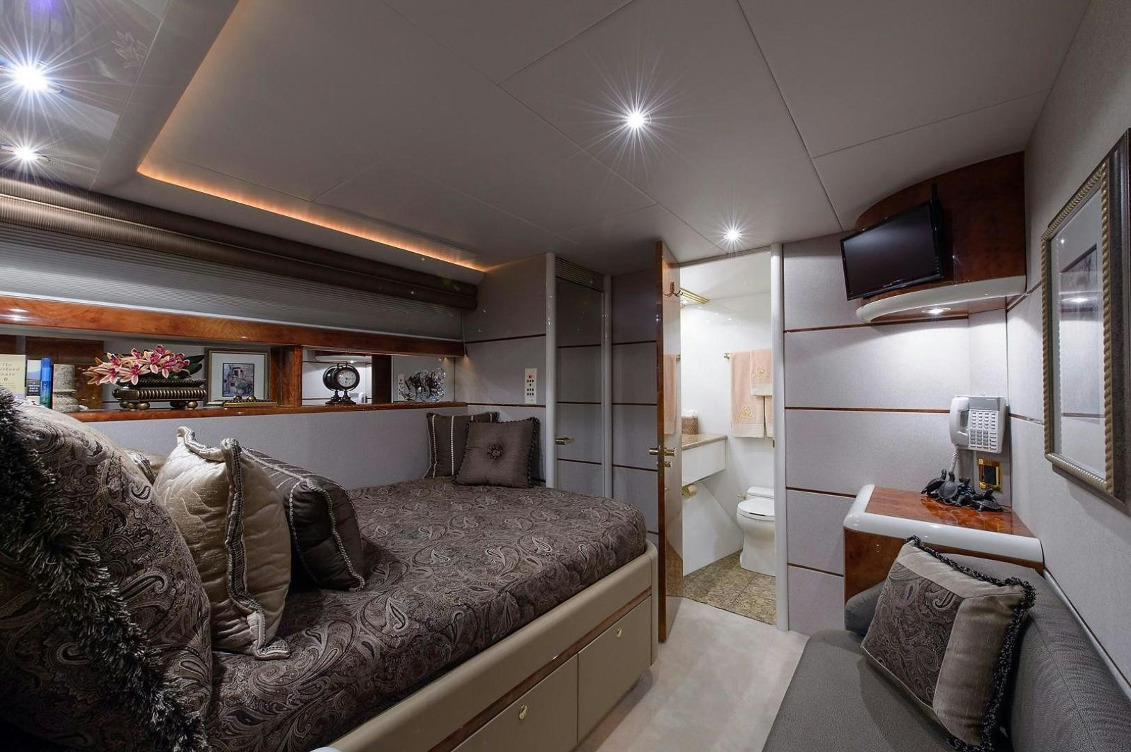 a living room with a couch and a bed aboard BIG WAVE Yacht for Sale