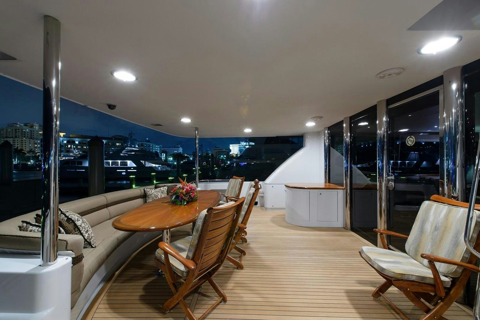 a room with a table and chairs aboard BIG WAVE Yacht for Sale