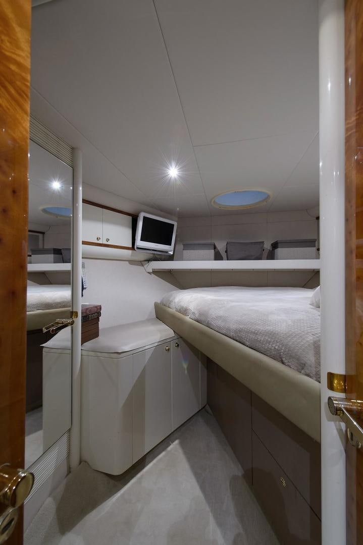 a bathroom with a bed and a television aboard BIG WAVE Yacht for Sale
