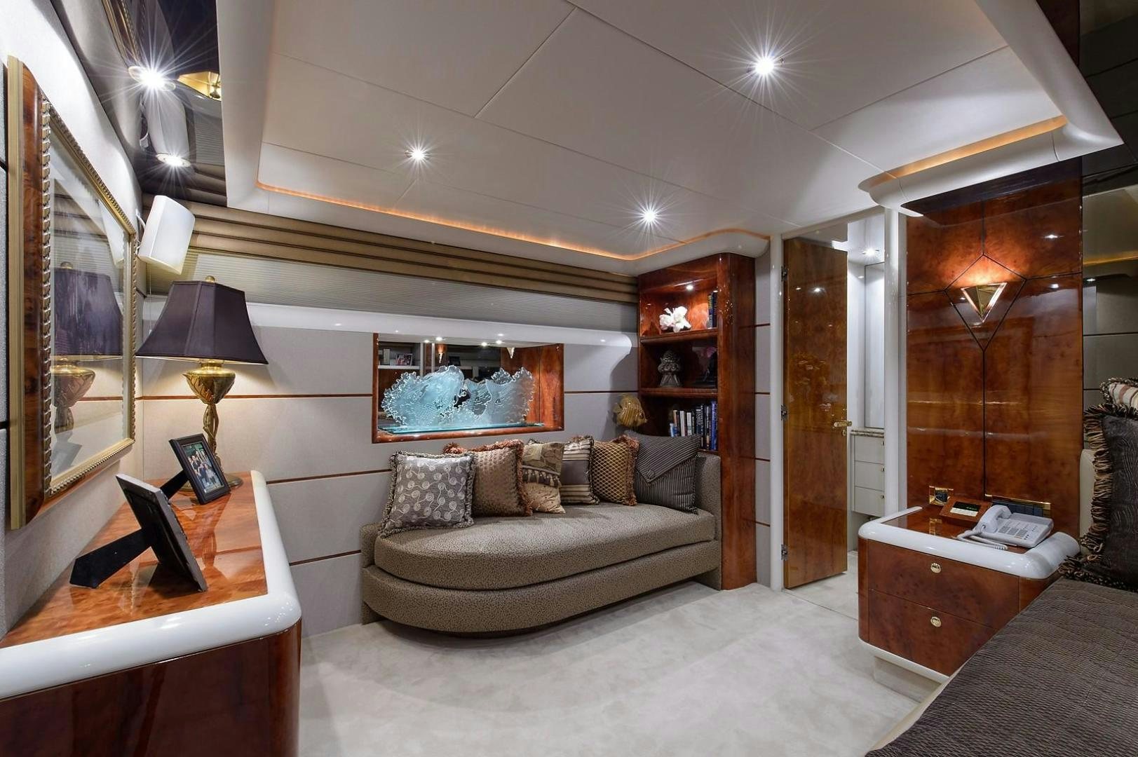 a living room with a couch and a mirror aboard BIG WAVE Yacht for Sale