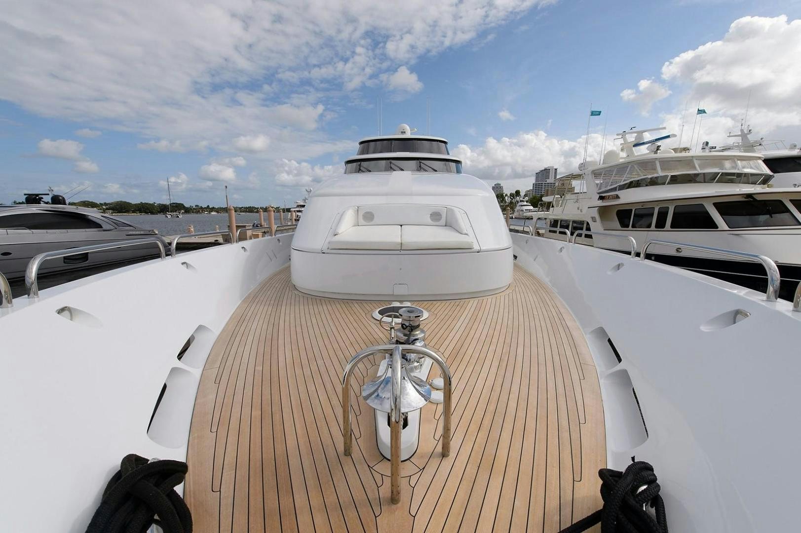 a deck with a boat and a water bottle on it aboard BIG WAVE Yacht for Sale