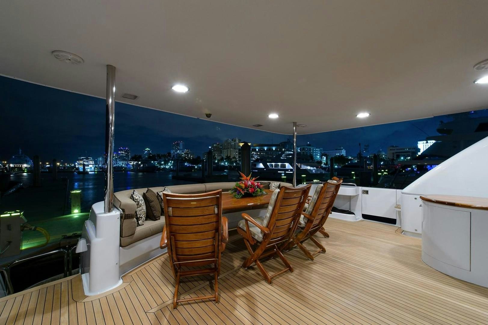 a room with a table and chairs aboard BIG WAVE Yacht for Sale