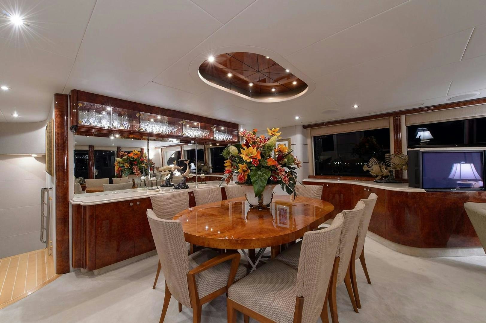 a dining room with a table and chairs aboard BIG WAVE Yacht for Sale