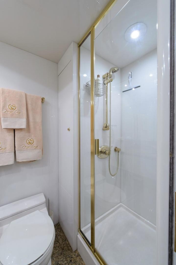 a bathroom with a shower and toilet aboard BIG WAVE Yacht for Sale