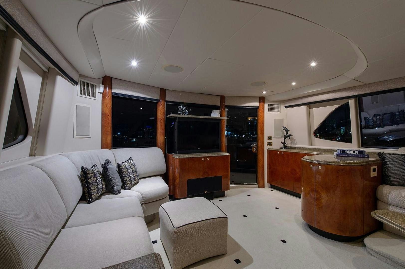 a living room with a couch and a television aboard BIG WAVE Yacht for Sale