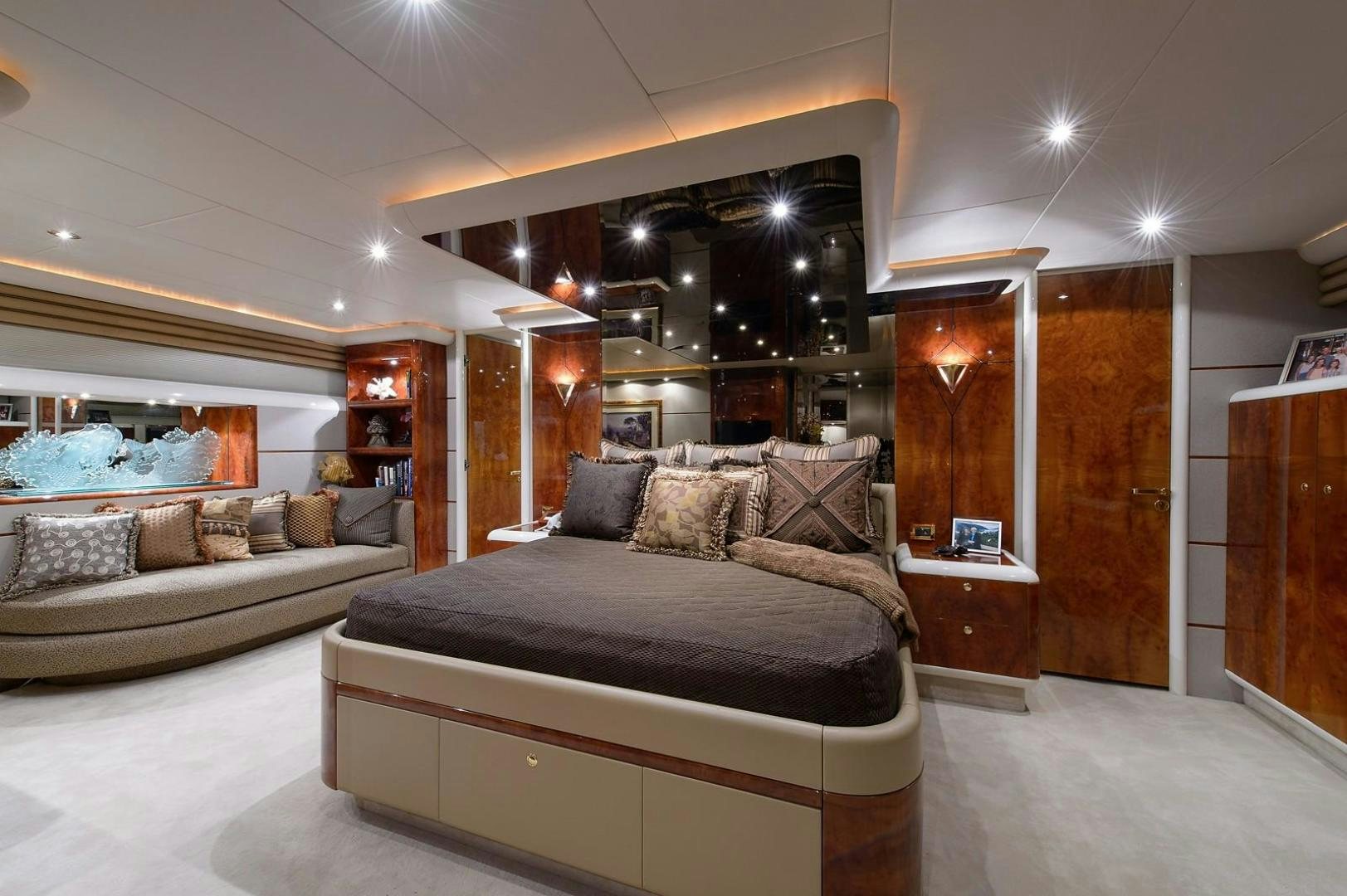 a living room with a large mirror aboard BIG WAVE Yacht for Sale
