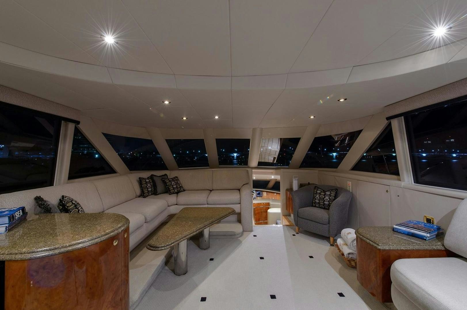 a living room with a couch and a table aboard BIG WAVE Yacht for Sale