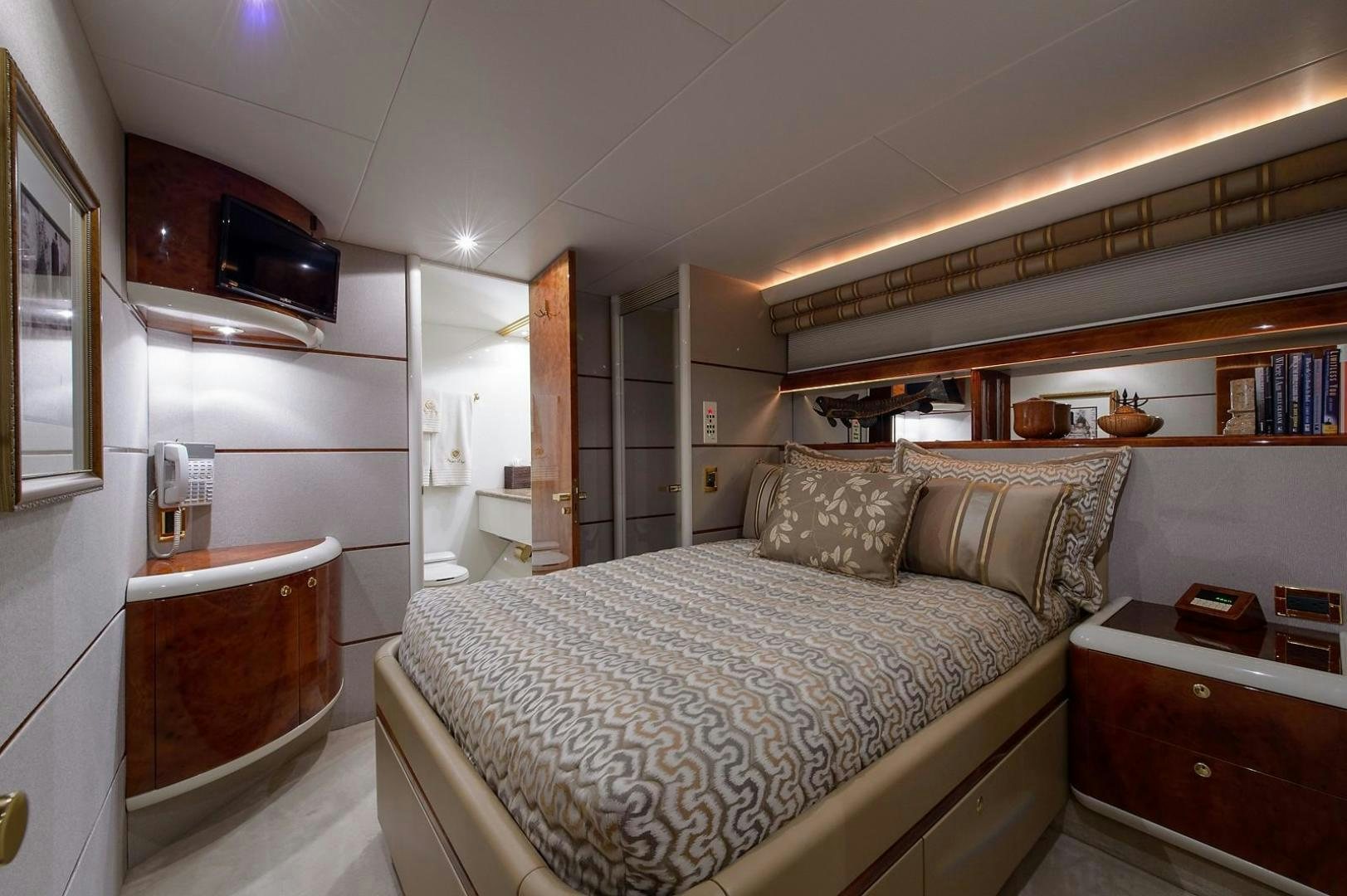 a bedroom with a bed and a window aboard BIG WAVE Yacht for Sale