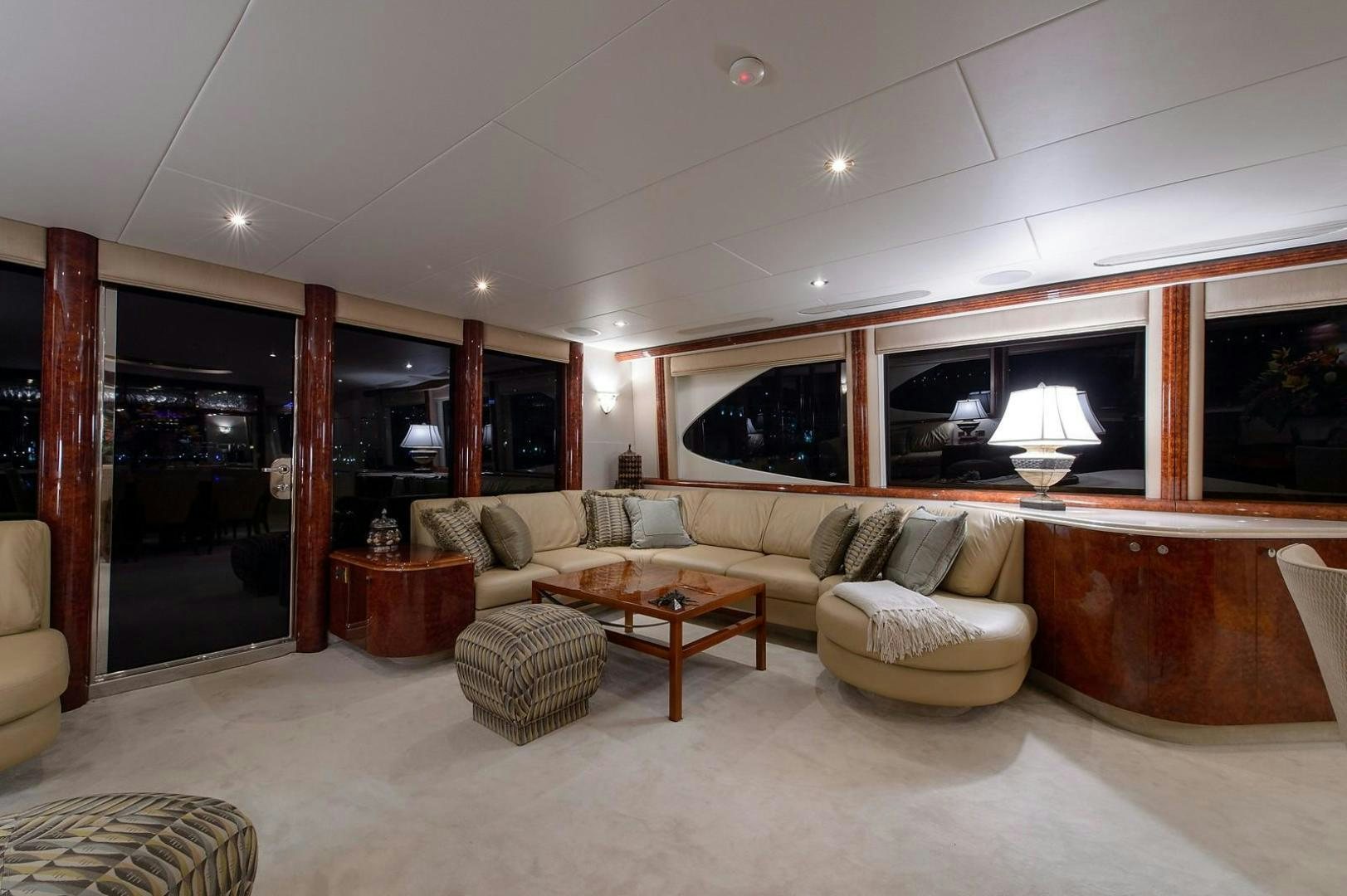 a living room with a couch and a table aboard BIG WAVE Yacht for Sale