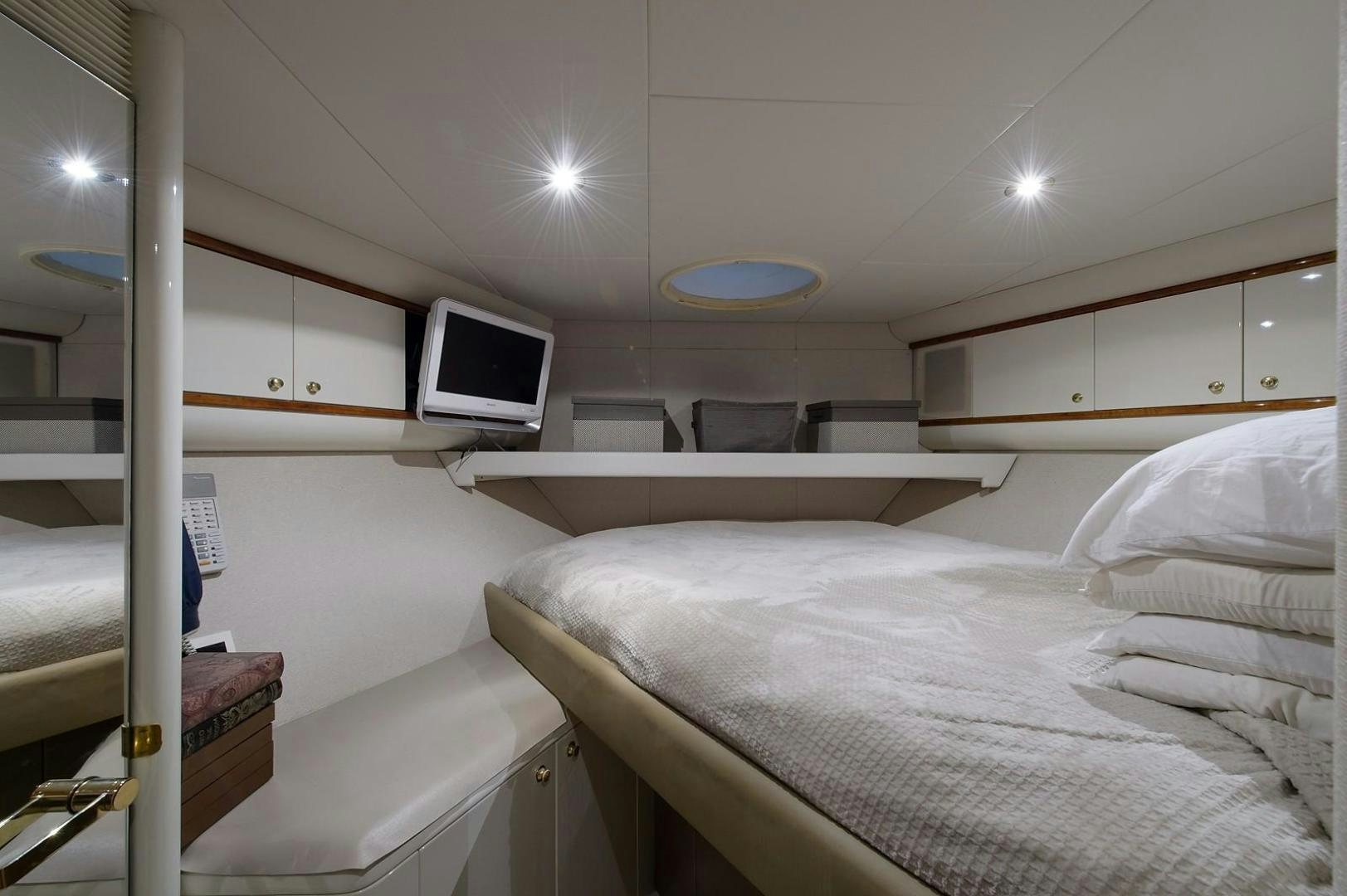 a room with a bed and a television aboard BIG WAVE Yacht for Sale