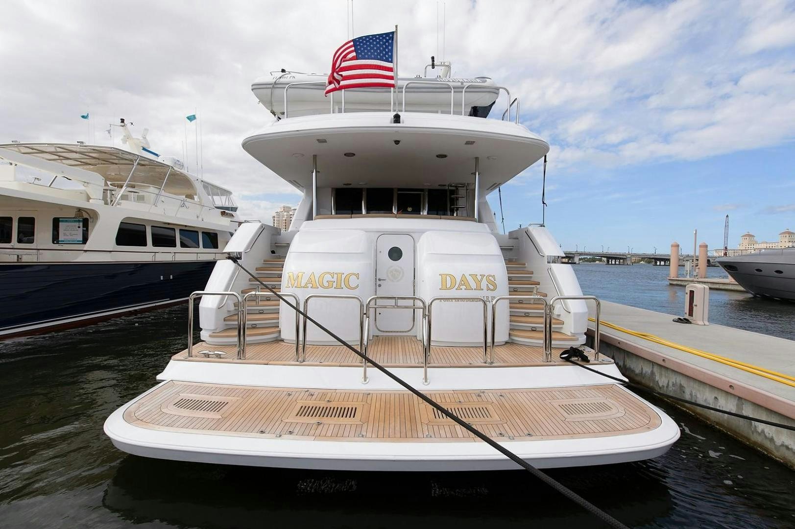 a boat with a flag on the front aboard BIG WAVE Yacht for Sale