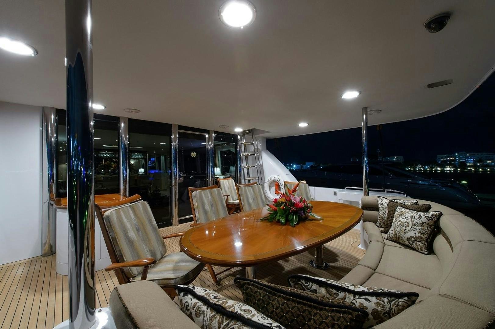 a living room with a table and chairs aboard BIG WAVE Yacht for Sale