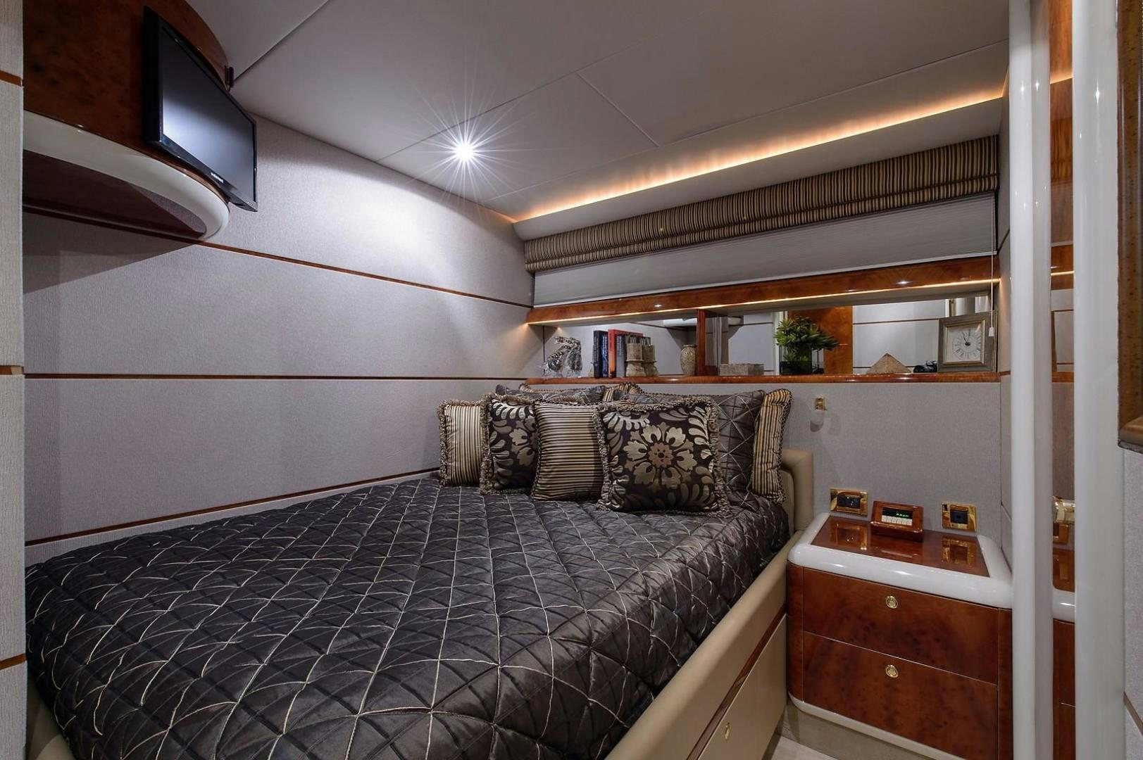 a bedroom with a bed and a desk aboard BIG WAVE Yacht for Sale