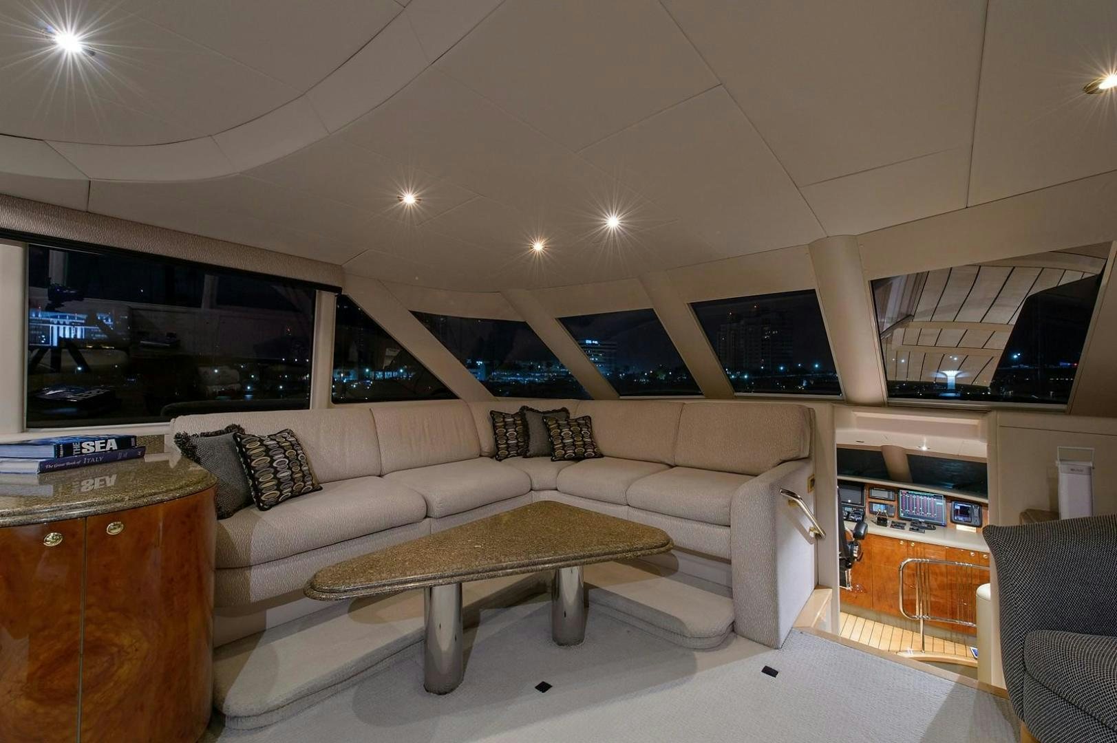 a living room with a large screen aboard BIG WAVE Yacht for Sale