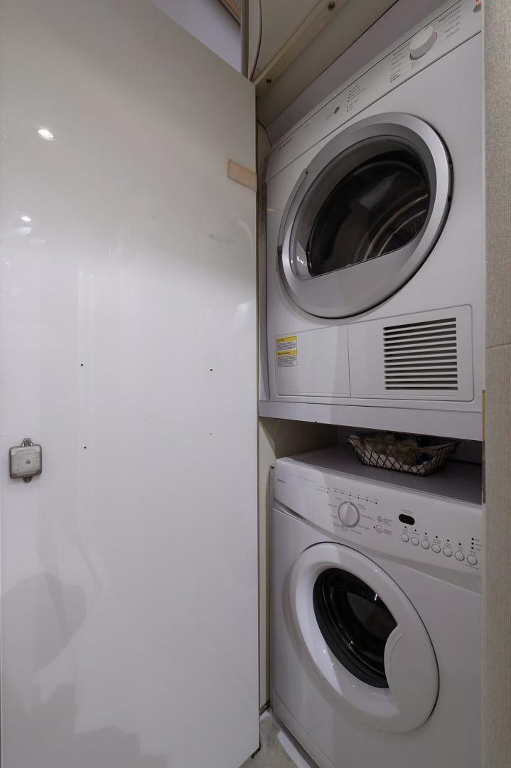 a laundry room with clothes dryer aboard BIG WAVE Yacht for Sale