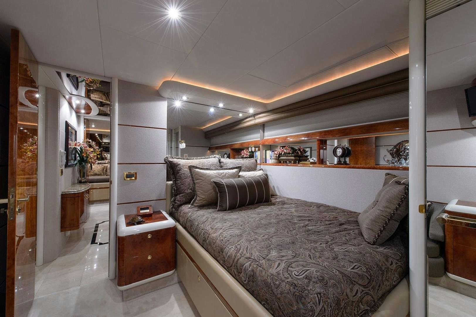 a bedroom with a bed and a mirror aboard BIG WAVE Yacht for Sale
