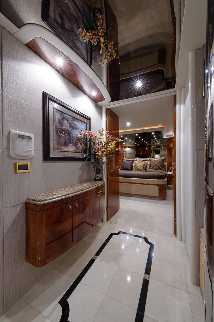 a room with a table and couch aboard BIG WAVE Yacht for Sale