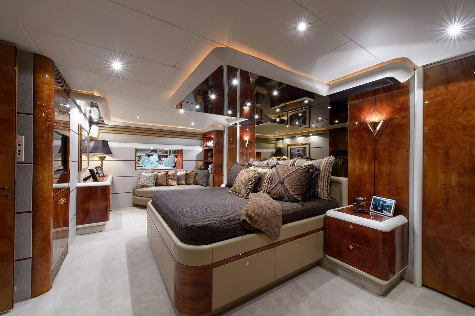 a living room with a large mirror aboard BIG WAVE Yacht for Sale