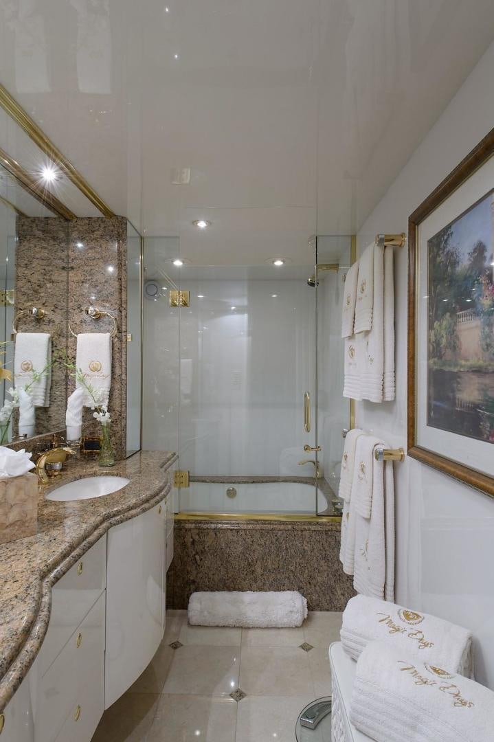 a bathroom with a sink and a bathtub aboard BIG WAVE Yacht for Sale