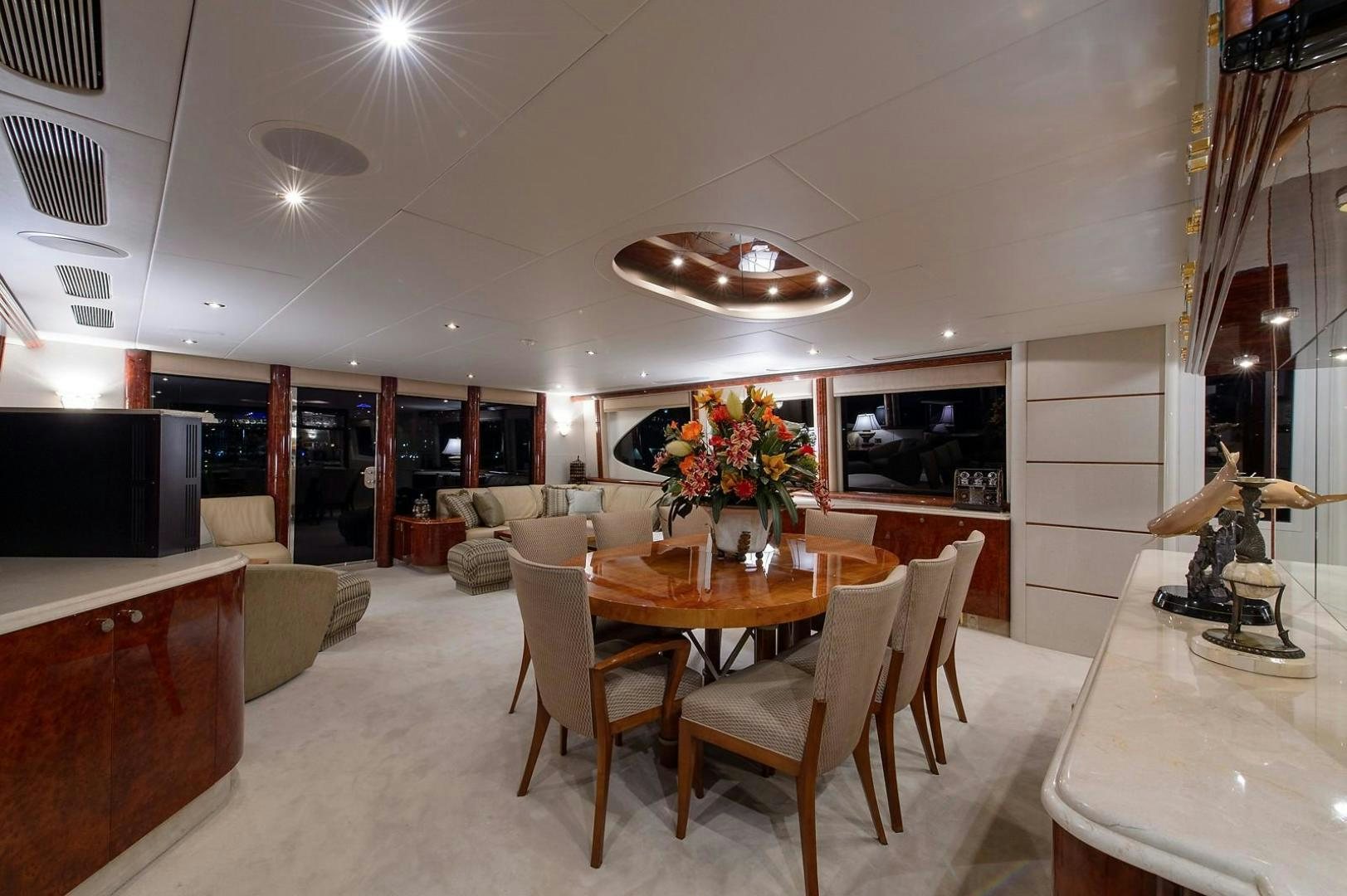 a room with a table and chairs aboard BIG WAVE Yacht for Sale