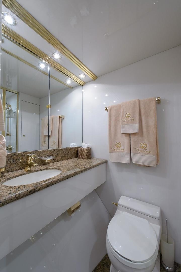 a bathroom with a sink and a toilet aboard BIG WAVE Yacht for Sale