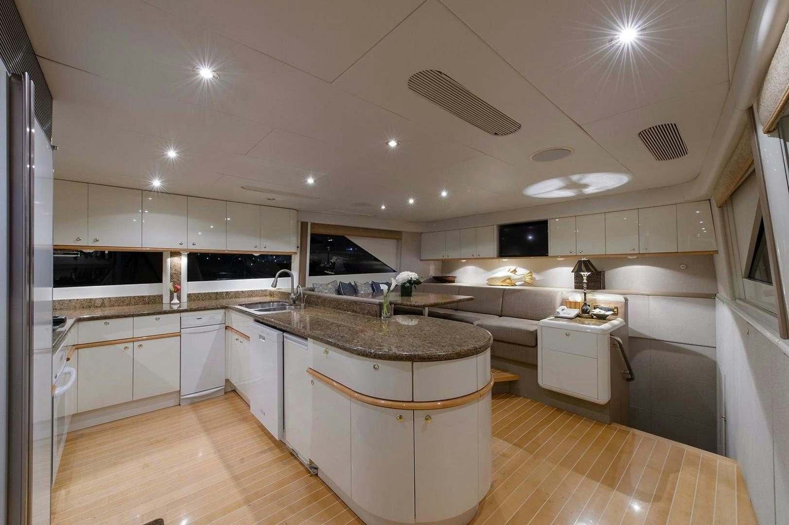 a large kitchen with white cabinets aboard BIG WAVE Yacht for Sale