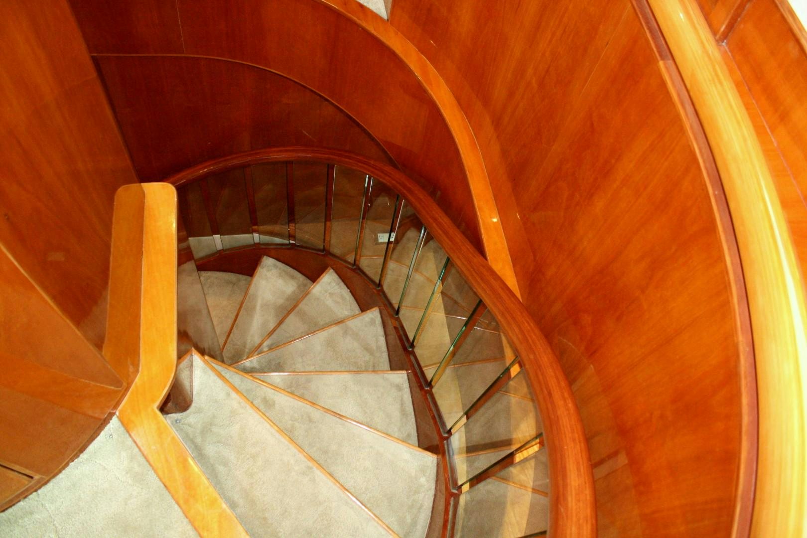 a staircase with a wood railing aboard CRYSTAL ANNE Yacht for Sale