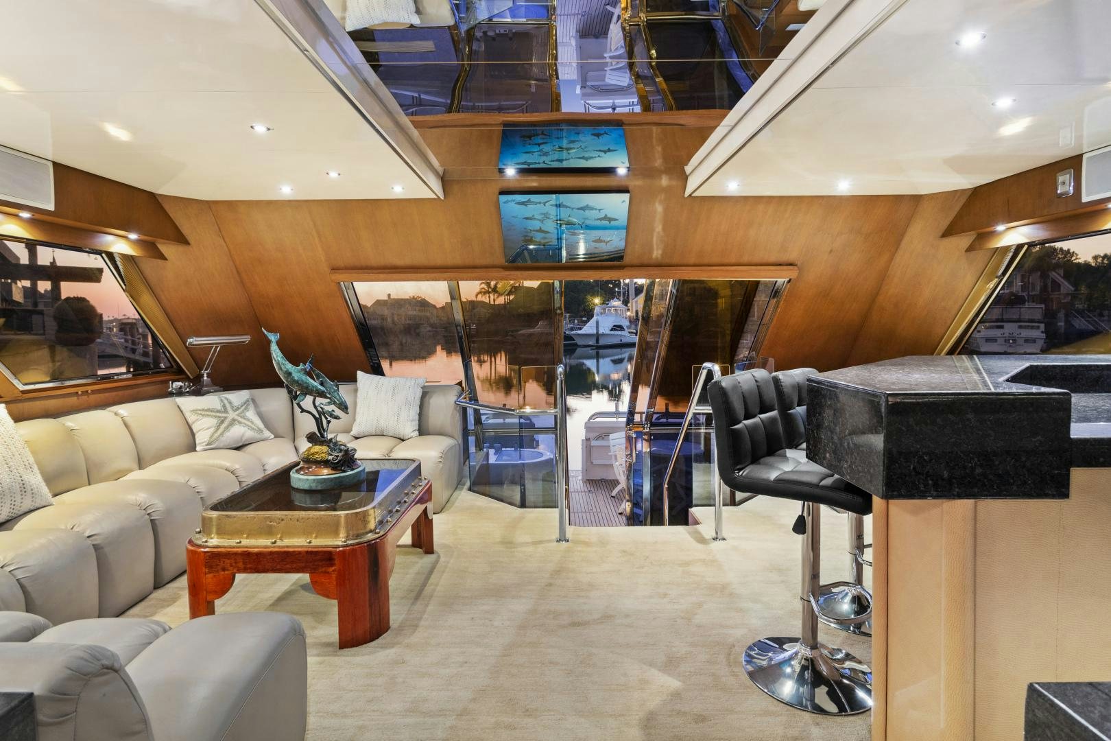 a living room with a large glass wall aboard THE FLYING DUTCHMAN Yacht for Sale