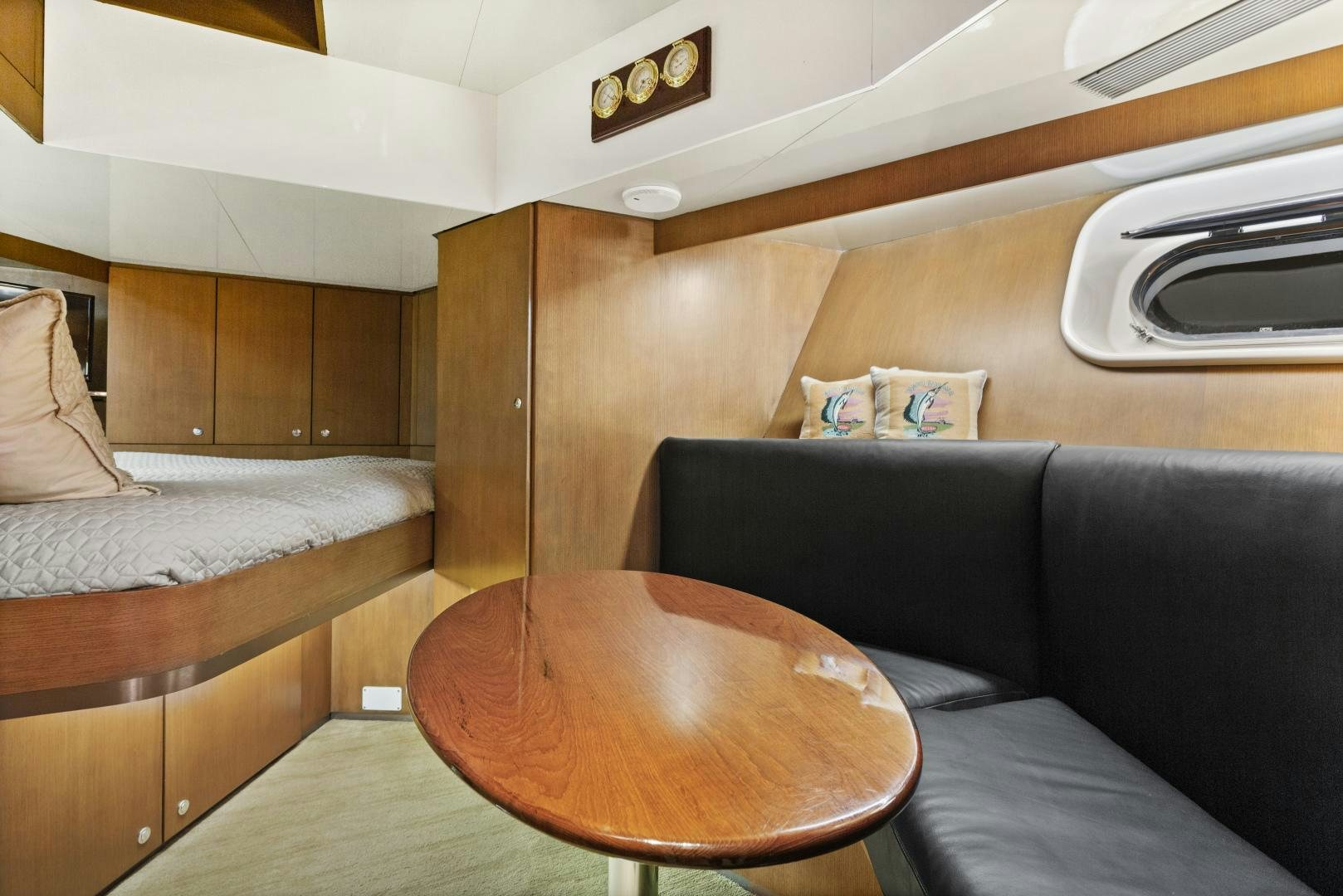 a couch and a table in a room aboard THE FLYING DUTCHMAN Yacht for Sale
