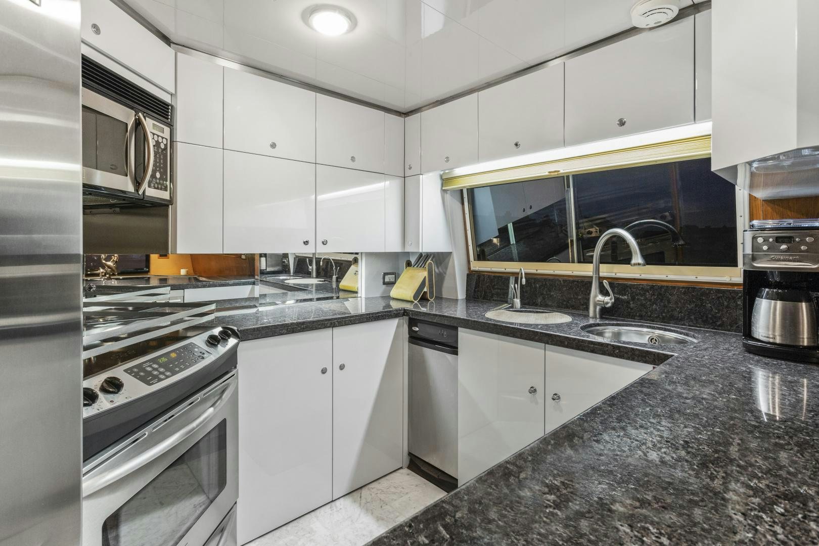 a kitchen with white cabinets aboard THE FLYING DUTCHMAN Yacht for Sale