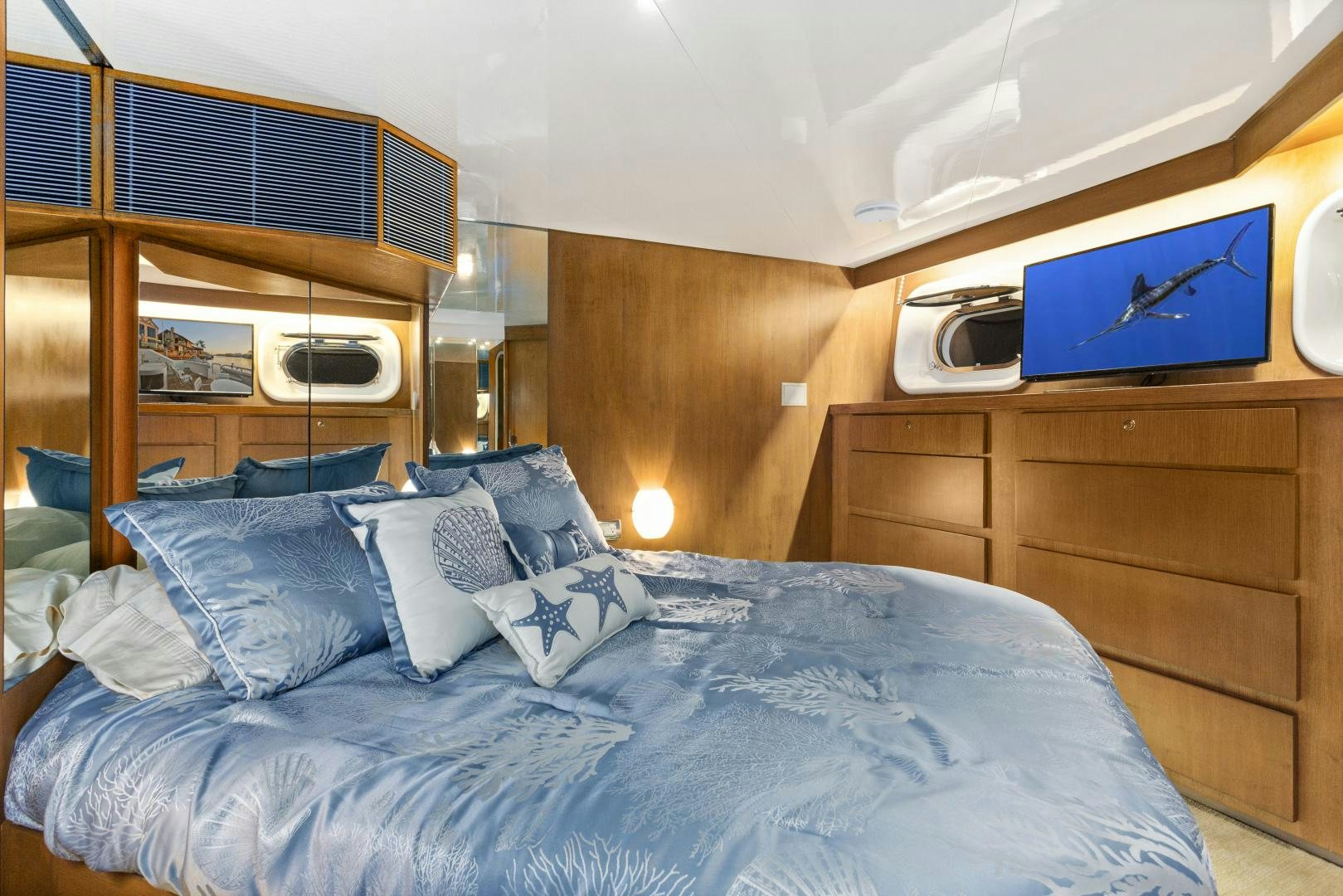 a bed with a television on the wall aboard THE FLYING DUTCHMAN Yacht for Sale