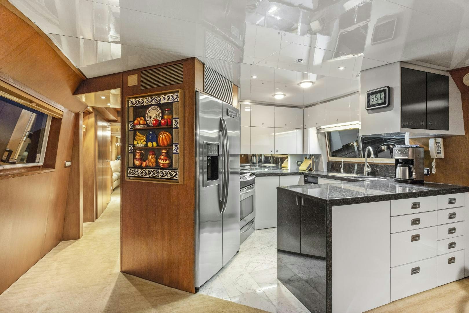a kitchen with a refrigerator and microwave aboard THE FLYING DUTCHMAN Yacht for Sale