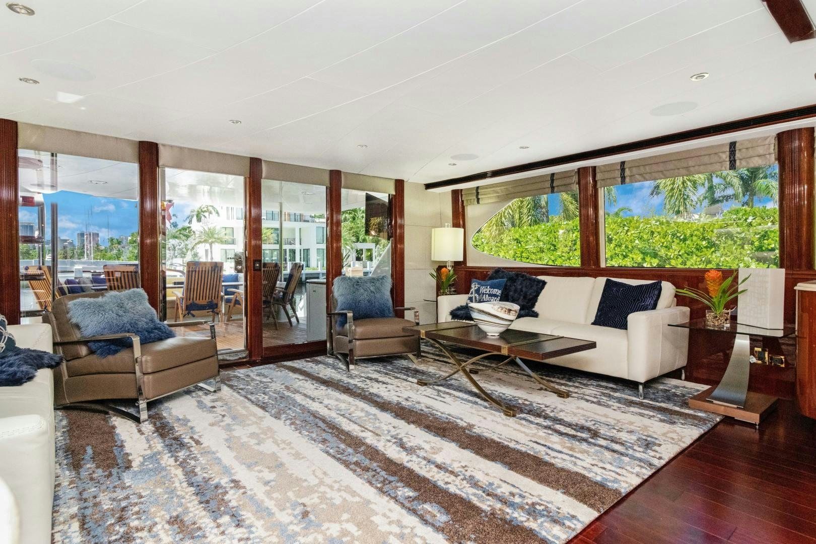 a living room with a large window aboard SUZANNE Yacht for Sale