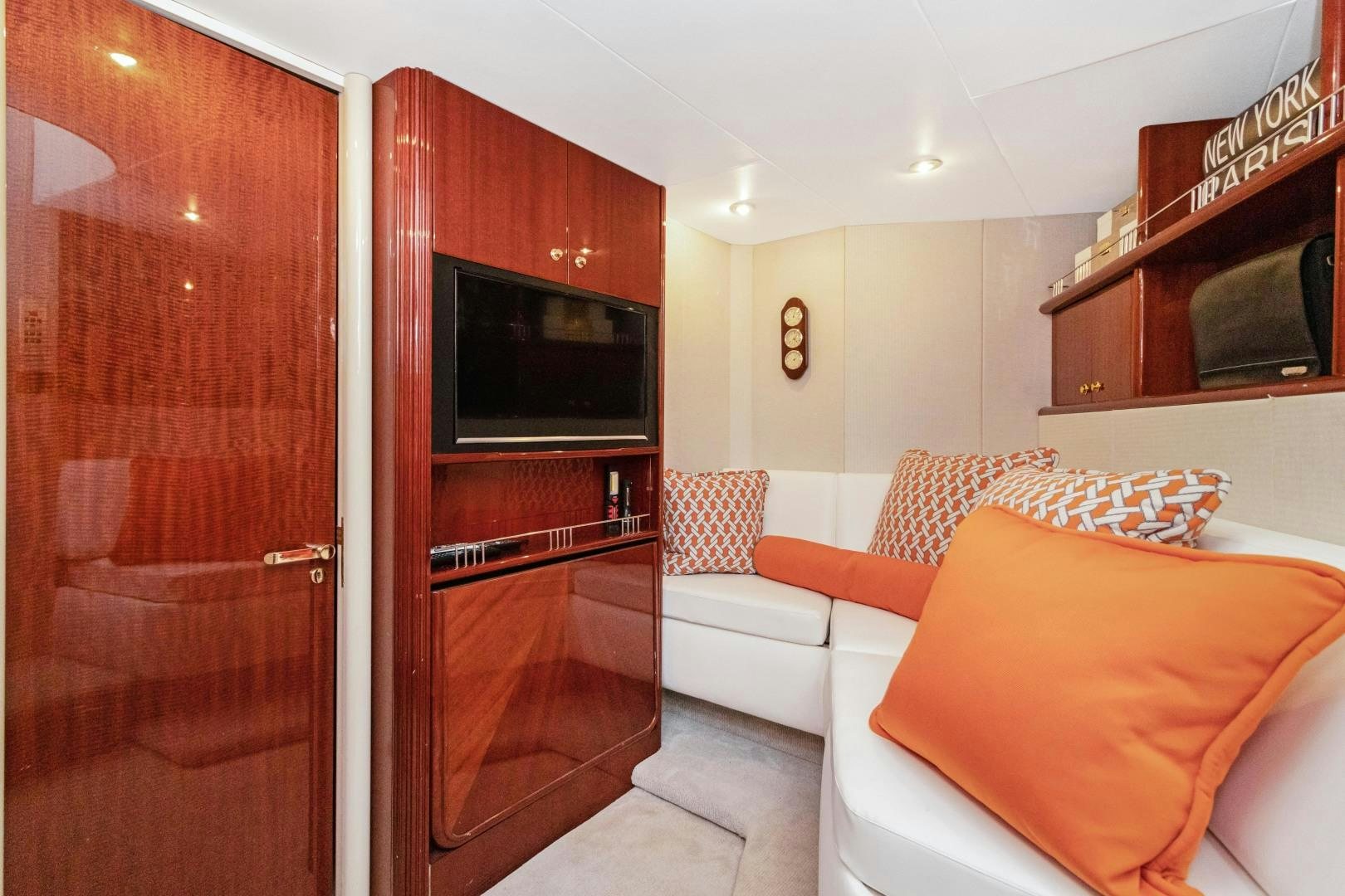 a living room with a wood cabinet aboard SUZANNE Yacht for Sale