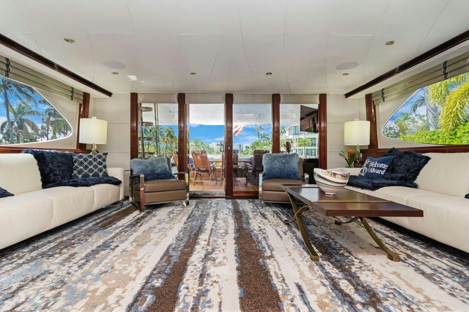a living room with a large glass door aboard SUZANNE Yacht for Sale