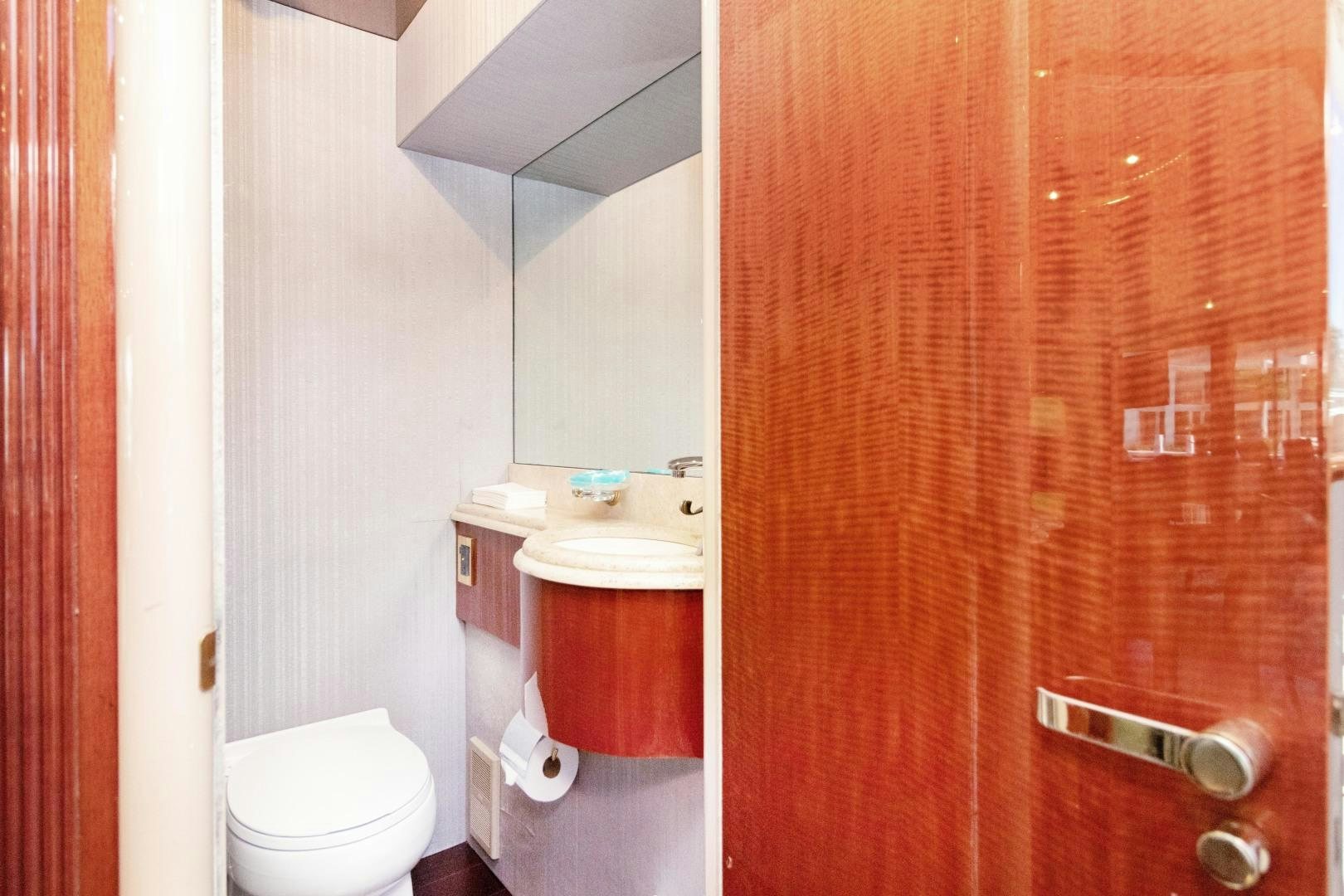 a bathroom with a toilet and a sink aboard SUZANNE Yacht for Sale