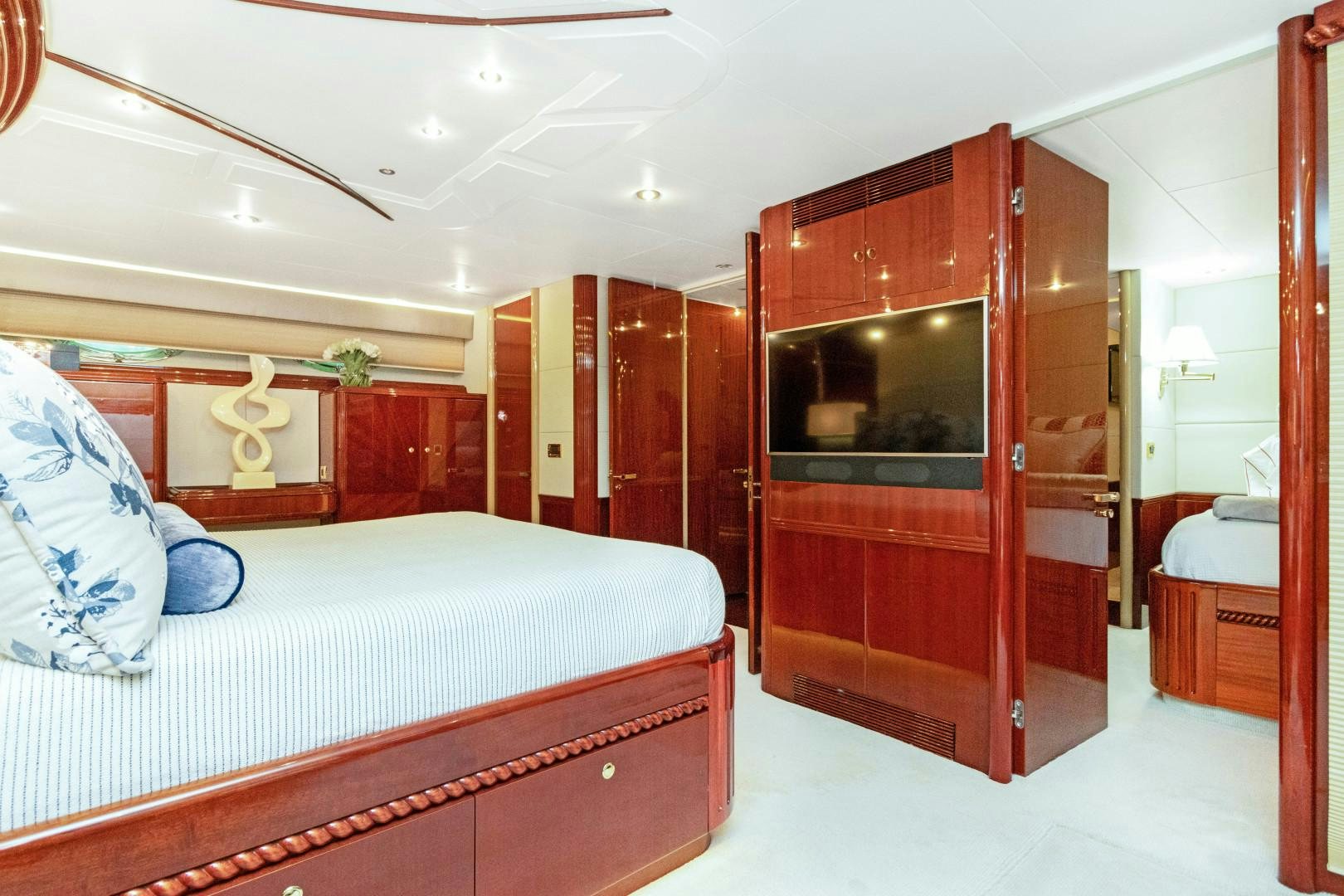 a bedroom with a bed and a closet aboard SUZANNE Yacht for Sale