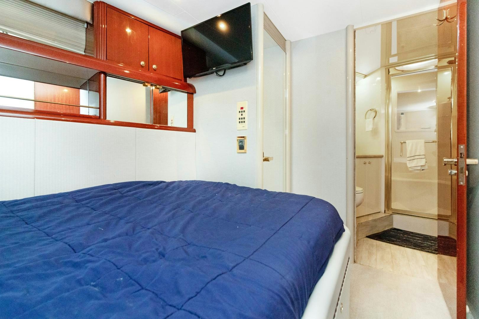a bedroom with a bed and a closet aboard SUZANNE Yacht for Sale