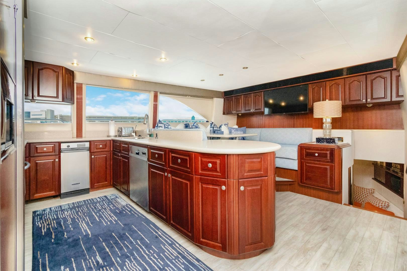 a large kitchen with wooden cabinets aboard SUZANNE Yacht for Sale