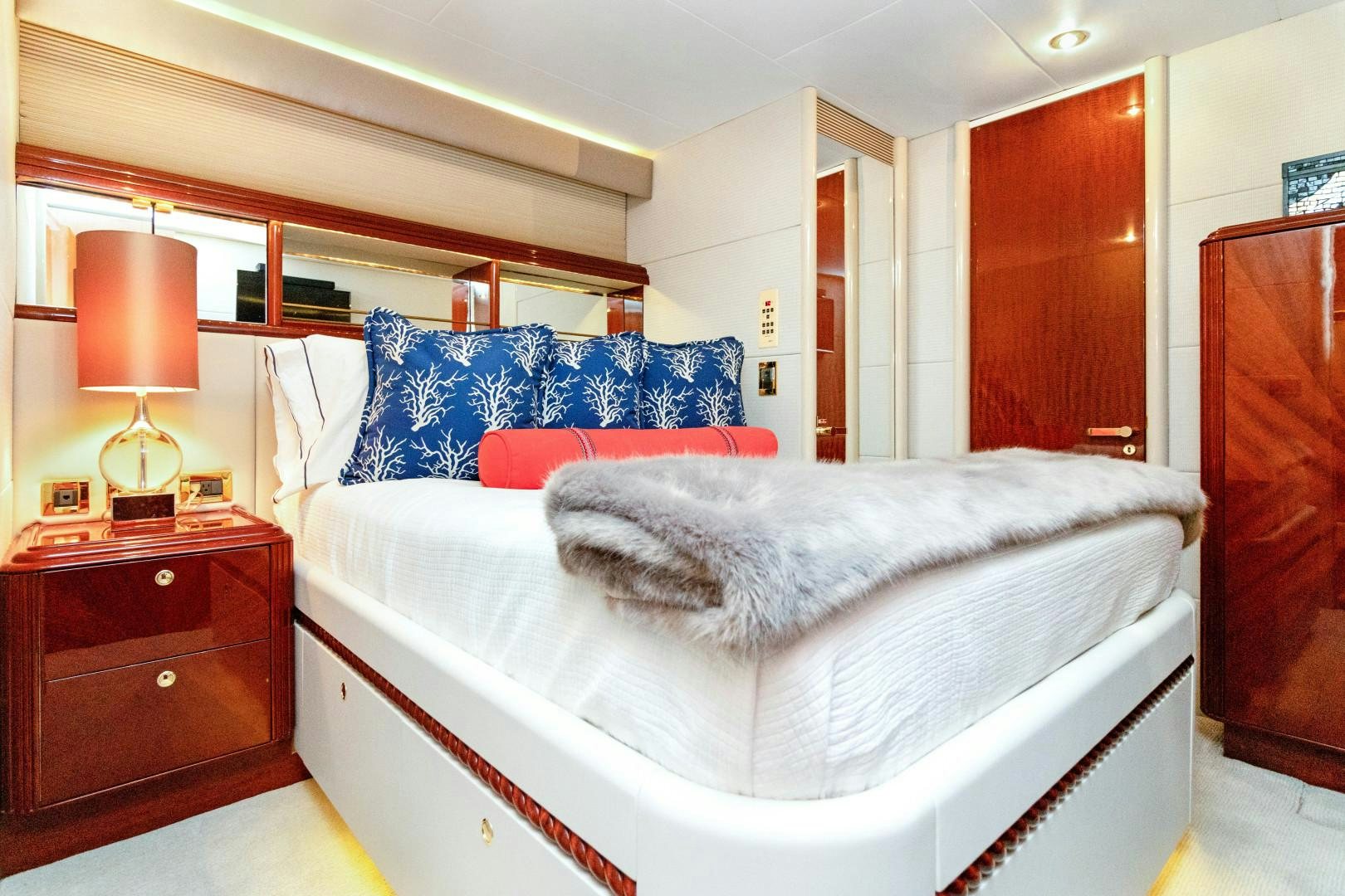 a bed with a blue pillow aboard SUZANNE Yacht for Sale