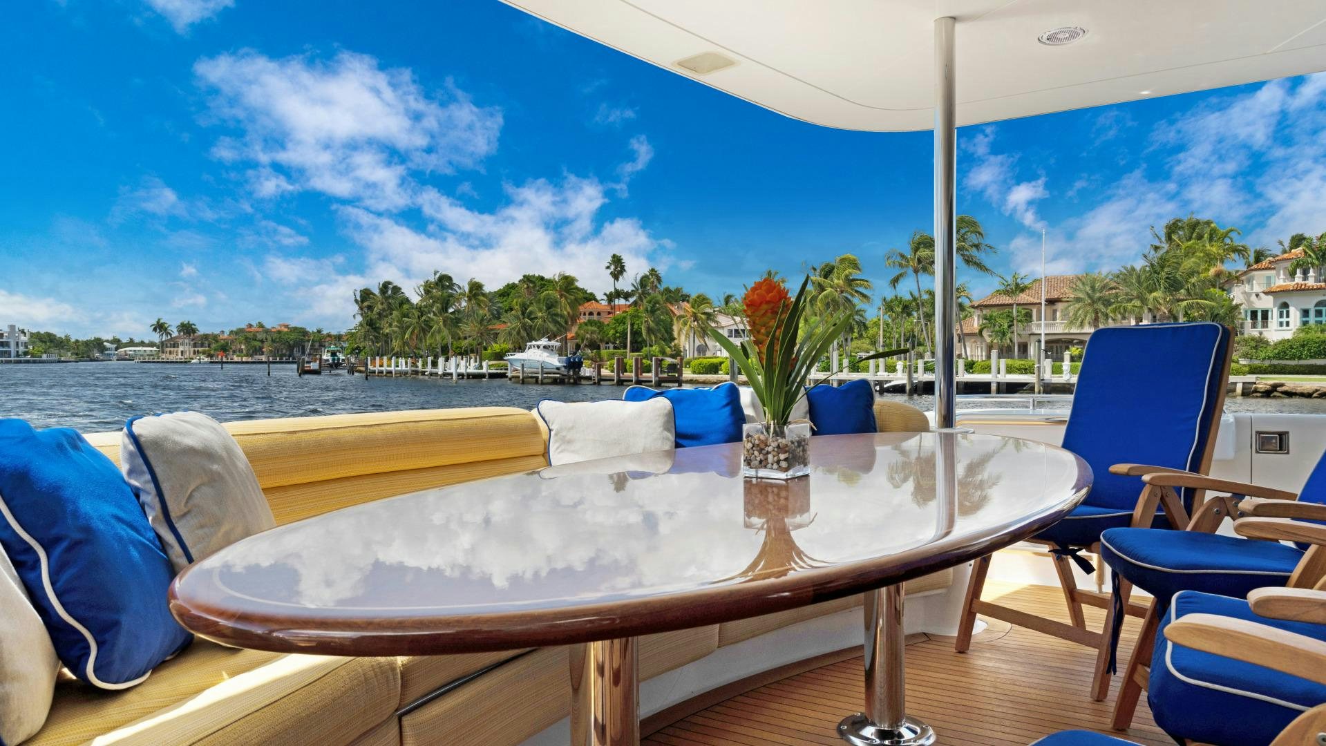 a table with chairs on it by the water aboard SUZANNE Yacht for Sale