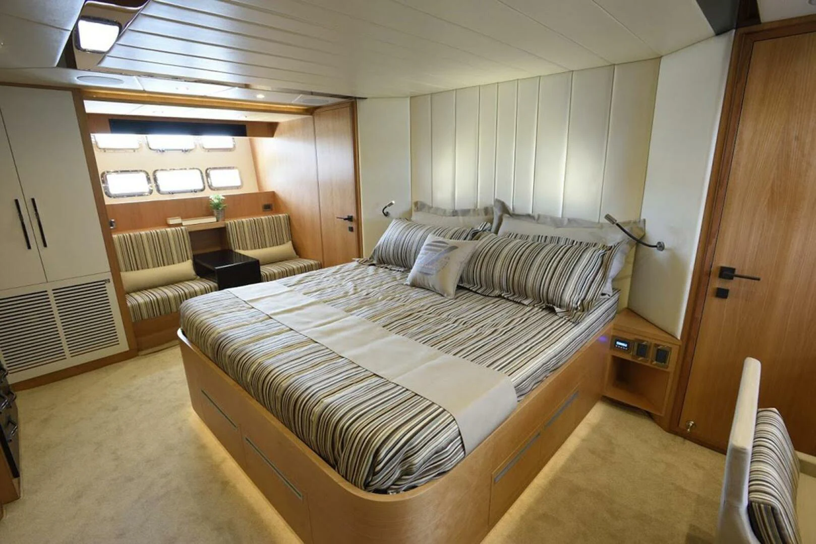 a room with a bed and a chair aboard JOHNSON 93 OPEN FB Yacht for Sale