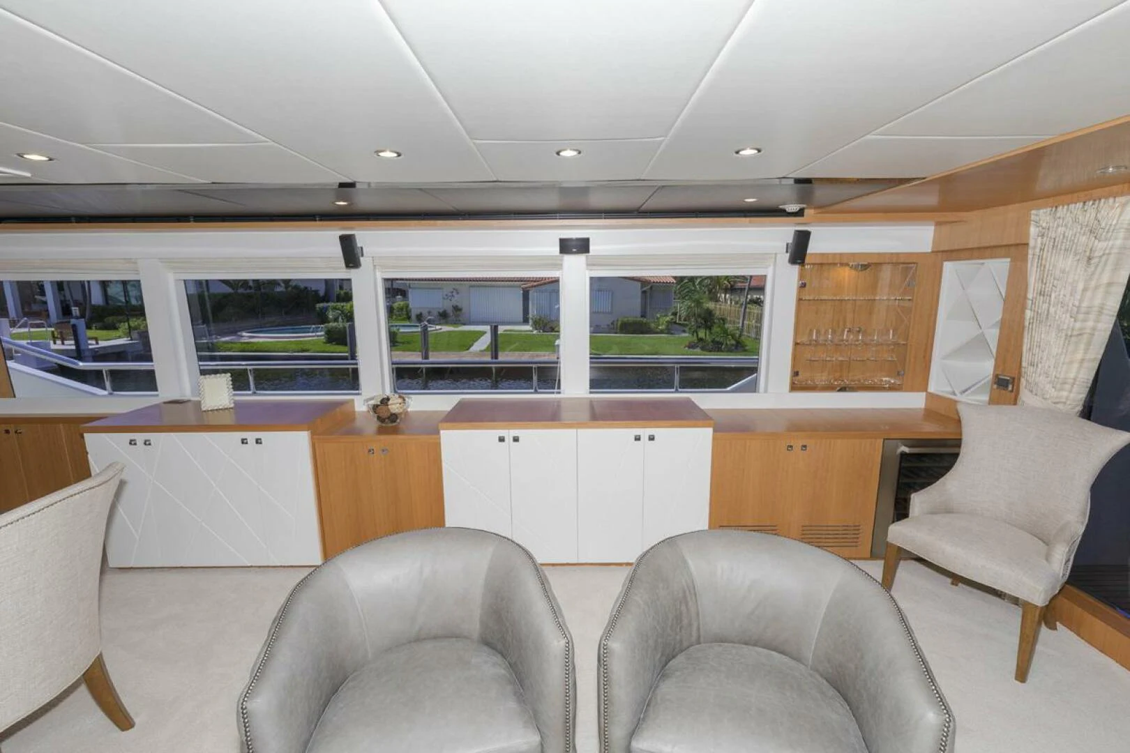 a room with chairs and a desk aboard JOHNSON 93 OPEN FB Yacht for Sale
