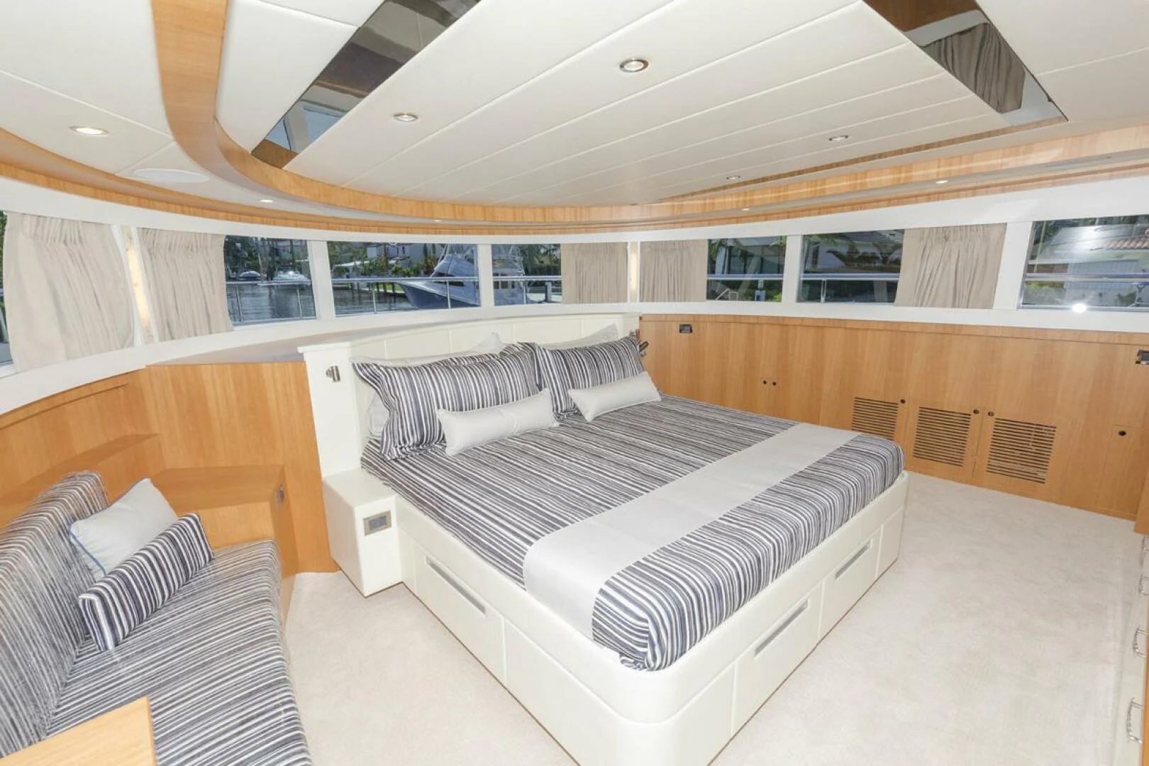 a room with a bed and a couch aboard JOHNSON 93 OPEN FB Yacht for Sale