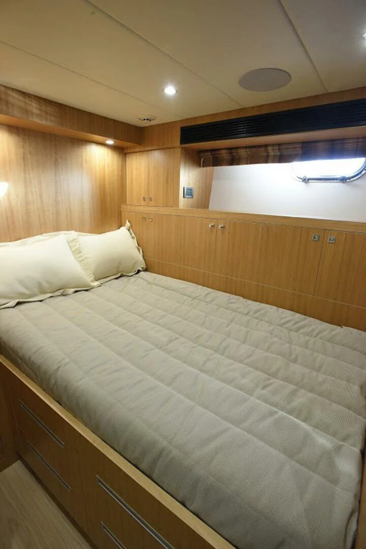 a bed with white sheets aboard JOHNSON 93 OPEN FB Yacht for Sale