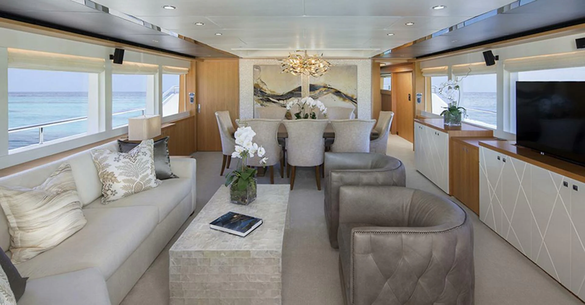 a living room with a table and chairs aboard JOHNSON 93 OPEN FB Yacht for Sale