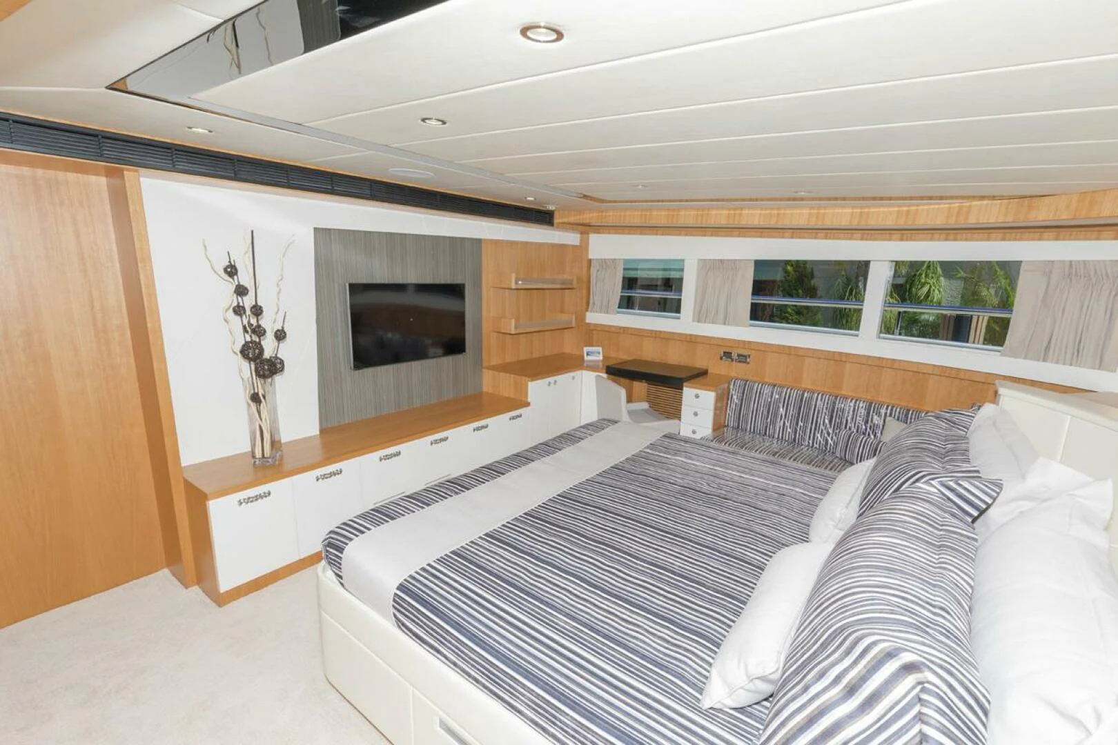 a room with a bed and a fireplace aboard JOHNSON 93 OPEN FB Yacht for Sale